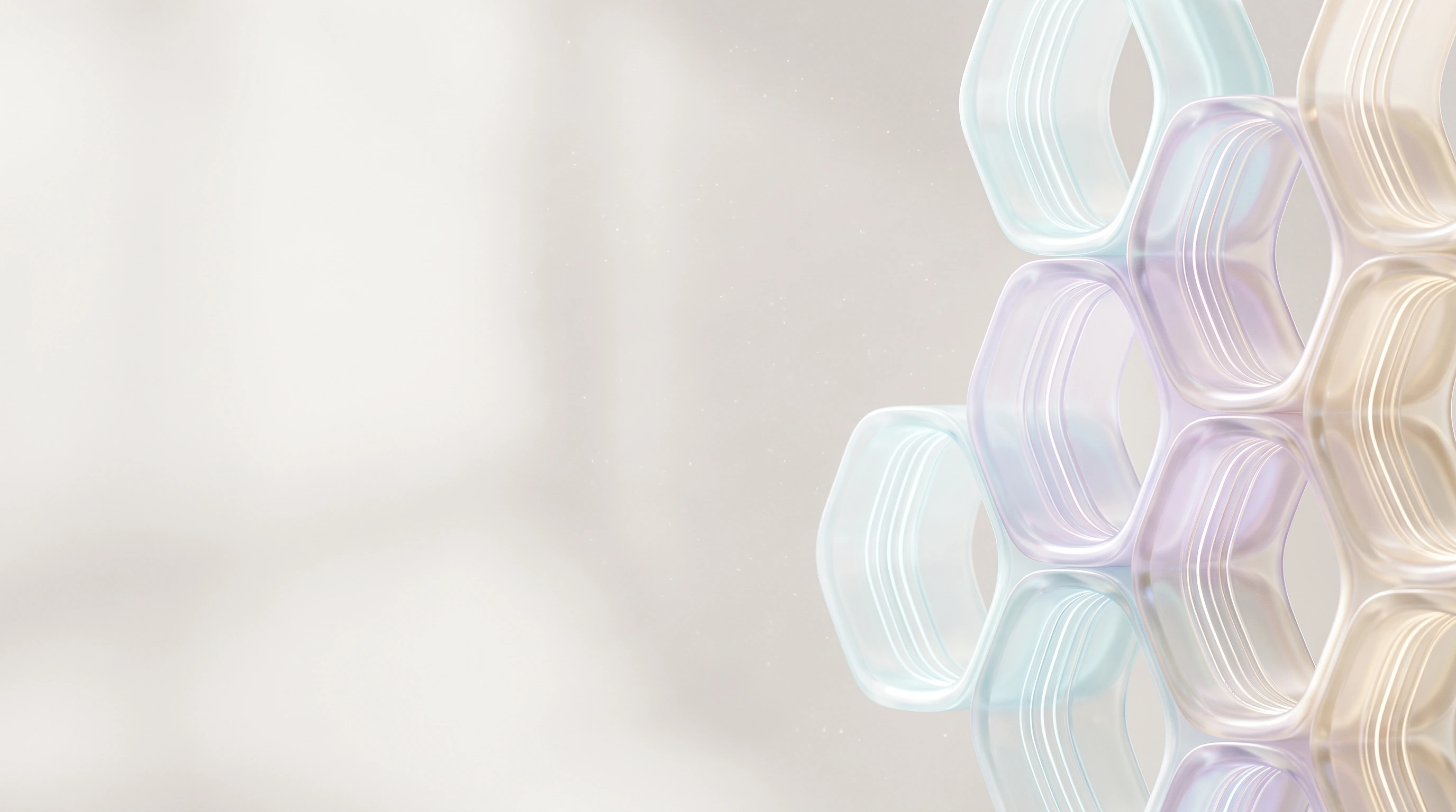 A close view of interlocking pearlescent hexagonal cells, showing the precision of how they join, with light running through their interiors.